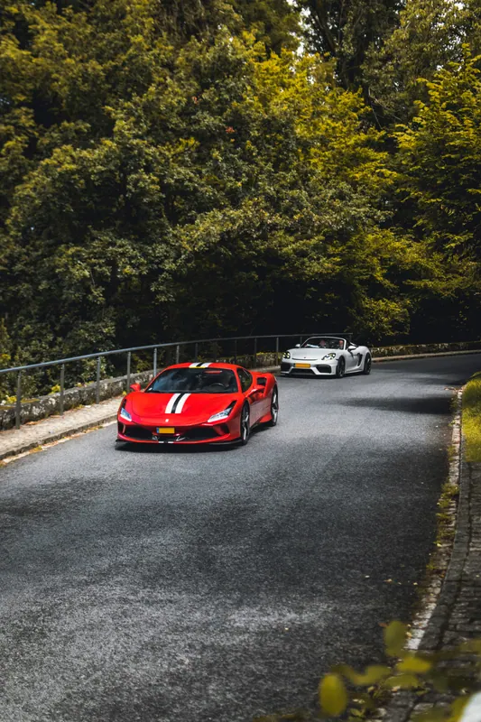 A red Ferrari driving along the tour route