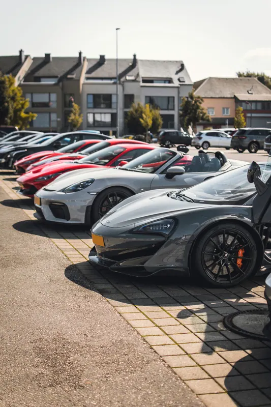 Sports cars parked together at a stop