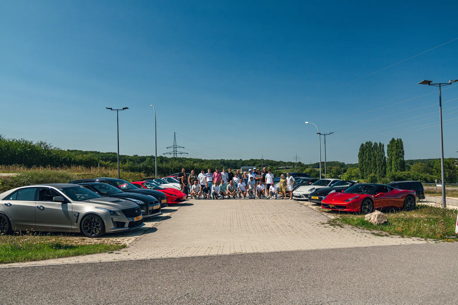 Tour participants between two rows of cars