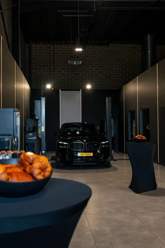 Cars displayed indoors at a tour stop