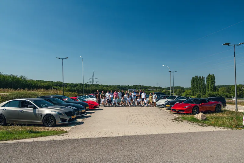 Tour participants between two rows of cars