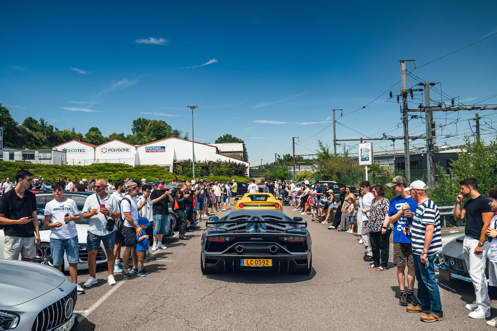 Visitors lining the car display
