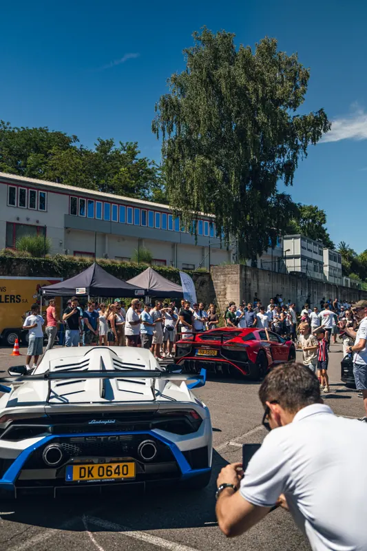 Visitors beside a white Ford GT
